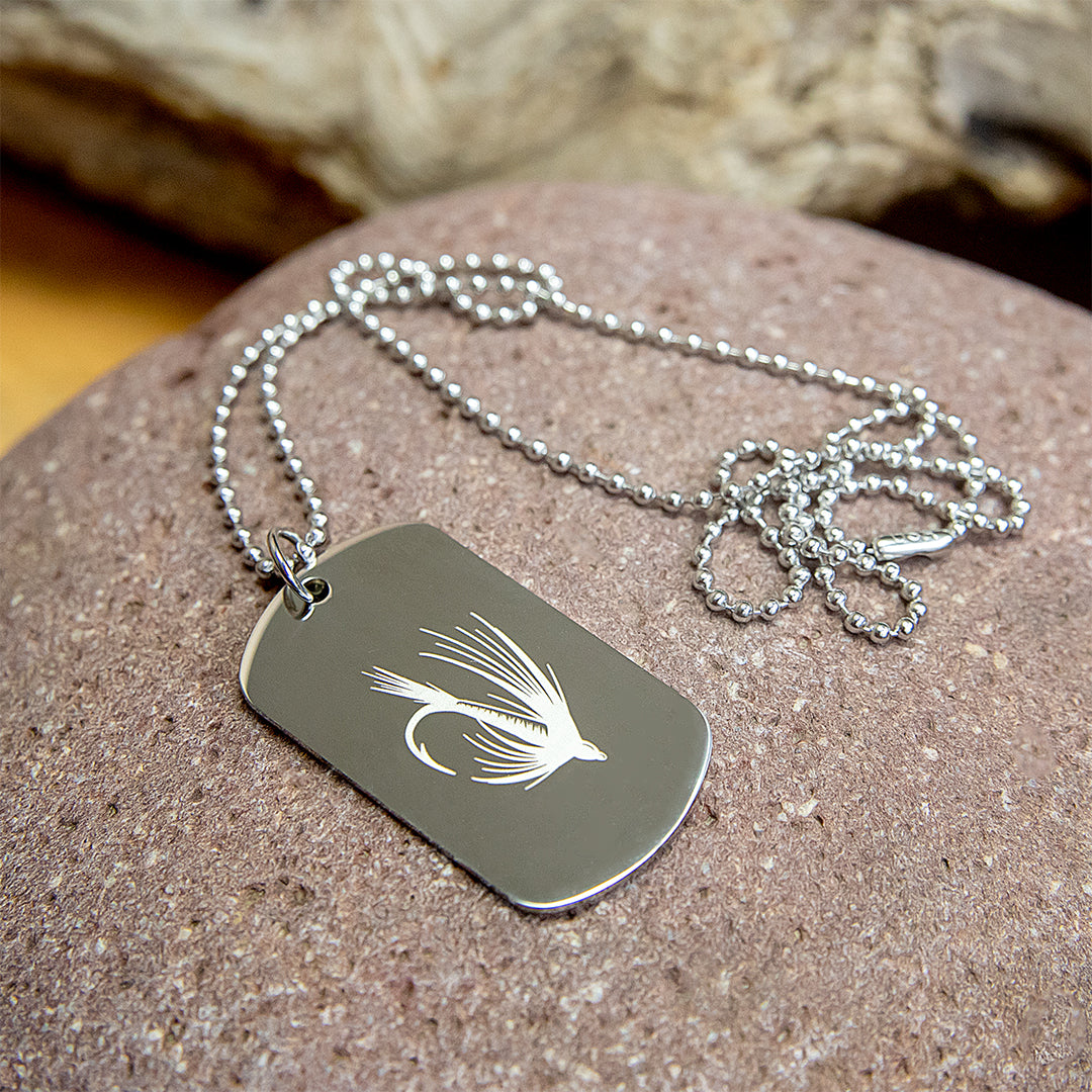 Stainless steel dog tag with engraved fly fishing designs.