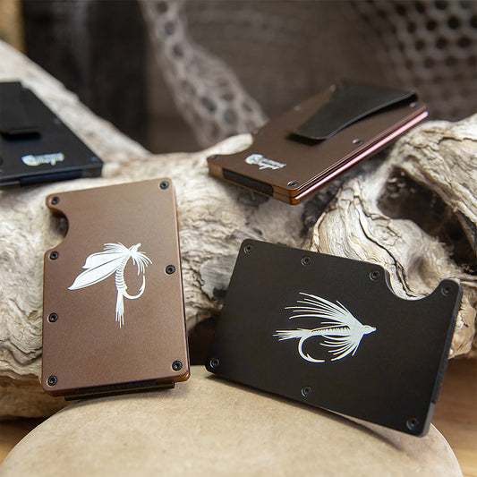 Three aluminum open card holders with a fly fishing lure design laser engraved.