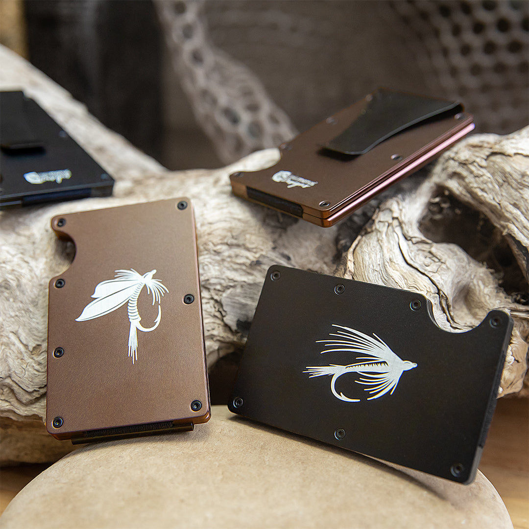 Three aluminum open card holders with a fly fishing lure design laser engraved.